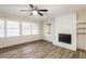 Living room with fireplace, wood-look floors and ceiling fan at 2273 Hampton Locust Grove Rd, Locust Grove, GA 30248