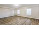Large bedroom featuring neutral walls and wood-like vinyl flooring at 2273 Hampton Locust Grove Rd, Locust Grove, GA 30248