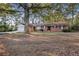 Brick ranch home with attached garage and mature trees at 2273 Hampton Locust Grove Rd, Locust Grove, GA 30248
