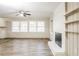 Living room with fireplace, wood-look floors and ceiling fan at 2273 Hampton Locust Grove Rd, Locust Grove, GA 30248