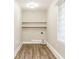 Bright laundry room with built-in shelving and vinyl flooring at 2273 Hampton Locust Grove Rd, Locust Grove, GA 30248