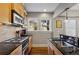 Modern kitchen with gas cooktop, light wood cabinetry, and a view into the dining area at 2 Collier Nw Rd # 5, Atlanta, GA 30309