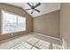 Bright bedroom with ceiling fan, large window, and taupe walls at 11447 Vinea Ln, Hampton, GA 30228