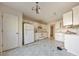 Kitchen with white cabinets and appliances, showing its overall condition at 11447 Vinea Ln, Hampton, GA 30228