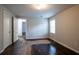 Simple bedroom with hardwood floors and an open door at 2229 Whites Mill Rd, Decatur, GA 30032
