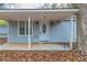 Quaint front porch with light blue siding and white door at 2229 Whites Mill Rd, Decatur, GA 30032