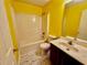 Clean bathroom with shower/tub and yellow walls at 4842 Hairston Park Sq, Stone Mountain, GA 30083