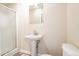 Clean bathroom with pedestal sink, shower, and toilet at 1496 E Highpoint Dr, Douglasville, GA 30134