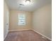 Simple bedroom with neutral walls and plush carpeting at 1496 E Highpoint Dr, Douglasville, GA 30134