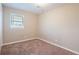 Cozy bedroom with a window and neutral colored carpet at 1496 E Highpoint Dr, Douglasville, GA 30134