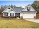 Two-story house with gray siding, brick accents, and two-car garage at 20 Madison Ct, Covington, GA 30016