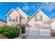 Two-story home with two-car garage, front yard landscaping, and a welcoming entryway at 2931 Two Lake Cir, Atlanta, GA 30349