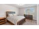 Bedroom with wood-look bed frame and dresser at 112 Leveret Rd, Locust Grove, GA 30248