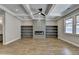 Spacious basement with built-in shelving, a fireplace, and coffered ceiling at 3757 Wasson Way, Brookhaven, GA 30319