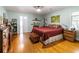 Spacious bedroom with hardwood floors, ample closet space, and a view of the backyard at 1028 Ridge Ave, Stone Mountain, GA 30083