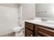 Clean bathroom with dark brown vanity and shower/tub combo at 7843 Shertall St, Fairburn, GA 30213
