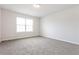 Bright bedroom featuring neutral walls and carpeted floor at 7843 Shertall St, Fairburn, GA 30213