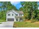 Two story home with gray garage door and white siding at 43 Sims St, Locust Grove, GA 30248