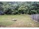 Spacious backyard with trees, fire pit, and privacy fence at 8443 Douglass Trl, Jonesboro, GA 30236