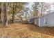 House with deck and large backyard covered in autumn leaves at 6415 Grey Fox Way, Riverdale, GA 30296