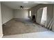 Large living room with a fireplace, carpeted floors, and neutral-colored walls at 6415 Grey Fox Way, Riverdale, GA 30296