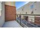 Balcony with metal railing and brick accent wall, overlooking the building's courtyard at 401 10Th Nw St # E218, Atlanta, GA 30318