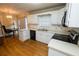 Kitchen features white cabinets, new stove, and hardwood floors at 2418 Henderson Rd, Tucker, GA 30084