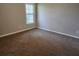 Well-lit bedroom with brown carpet and neutral walls at 1812 Lakewood Se Ave, Atlanta, GA 30315
