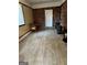 Finished basement with wood flooring, brick wall, and wood stove at 2962 Mcafee Rd, Decatur, GA 30032