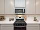 Modern kitchen with stainless steel appliances and white cabinetry at 580 Pennsy Aly, Mableton, GA 30126