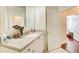 Well-lit bathroom with a vanity, large mirror, and access to another room at 4100 Paces Se Walk # 1306, Atlanta, GA 30339