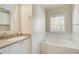 Bathroom boasts a bathtub, vanity with a large mirror and neutral colors at 4100 Paces Se Walk # 1306, Atlanta, GA 30339