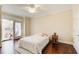 Bright bedroom with hardwood floors and access to a private balcony at 4100 Paces Se Walk # 1306, Atlanta, GA 30339