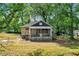 Stone cottage with porch, needs renovation, surrounded by trees at 1162 Joseph E Boone Nw Blvd, Atlanta, GA 30314