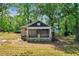 Stone cottage with porch, needs renovation, surrounded by trees at 1162 Joseph E Boone Nw Blvd, Atlanta, GA 30314