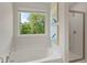 Relaxing bathroom with a garden-view window and soaking tub at 8 Camellia Dr, Fairburn, GA 30213