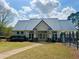 Community clubhouse with metal roof and landscaping at 358 Lake Forest Ct, Lawrenceville, GA 30043