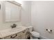 Elegant powder room with a pedestal sink and toilet at 512 Cooper Lake Se Rd, Mableton, GA 30126