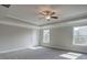 Large bedroom with ceiling fan, carpet, and multiple windows at 730 Cams Crk, Mcdonough, GA 30253