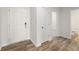 Bright entryway with wood-look flooring, coat closet and access to bathroom at 4187 Viola Pl, Atlanta, GA 30349