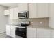 Modern kitchen with stainless steel range, white cabinets, and granite countertops at 4187 Viola Pl, Atlanta, GA 30349