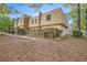 Rear view of townhome with wooden fence and landscaping at 6424 Woodstone Way, Morrow, GA 30260