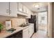 Kitchen with white cabinets and granite countertops at 6424 Woodstone Way, Morrow, GA 30260