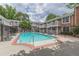 Community pool area with surrounding lounge chairs and brick buildings at 869 Briarcliff Ne Rd # B20, Atlanta, GA 30306