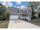 Two story brick home with attached garage and red door at 909 Galloway Ct, Mcdonough, GA 30253