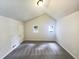 Bright bedroom with grey carpet, two windows, and a door at 4405 Cary Dr, Snellville, GA 30039