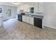 Kitchen features white cabinets, grey countertops, and black appliances at 4405 Cary Dr, Snellville, GA 30039