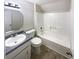 Clean bathroom with a tub, toilet and vanity with grey countertop at 4405 Cary Dr, Snellville, GA 30039