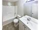 Bathroom features a tub, toilet, and vanity with a stained glass window at 4405 Cary Dr, Snellville, GA 30039
