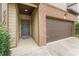 Front entry with gray door and brown garage door, brick and siding exterior at 4910 Rapahoe Trl, Atlanta, GA 30349